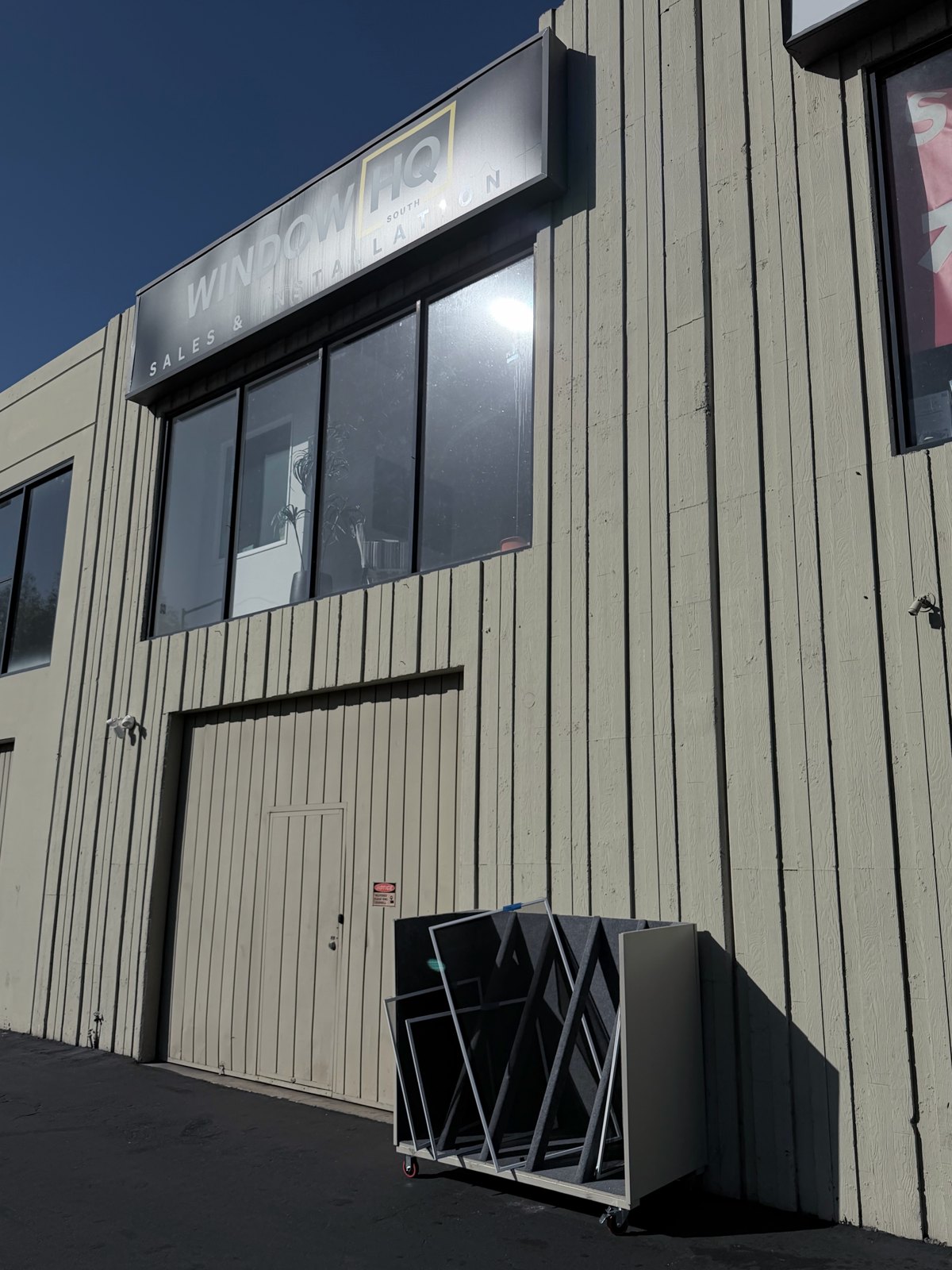 Window screen drop-off and pick-up box behind the building, beneath the Window HQ sign.